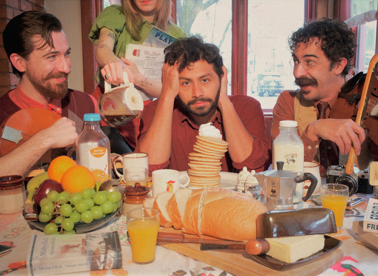 Sal seated at a breakfast table with C.A. & Sonny